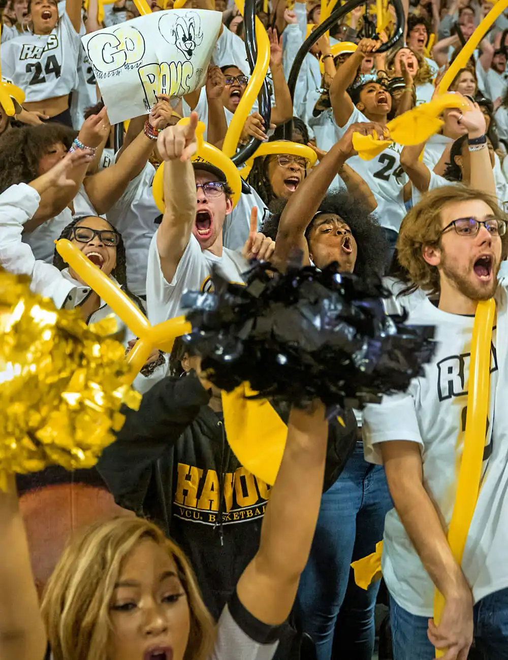 Large crowd of VCU student marching down the street in a school spirit parade